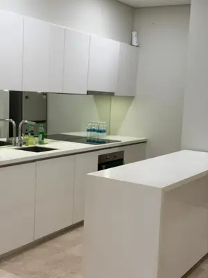 a white kitchen with white cabinets and a sink at Sky Suites KLCC by TD Luxury Homestay in Kuala Lumpur