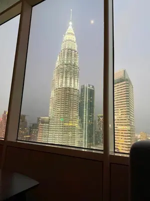 a view of a tall building from a window at Sky Suites KLCC by TD Luxury Homestay in Kuala Lumpur
