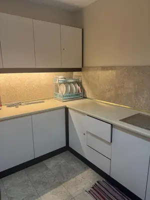 a kitchen with white cabinets and a counter top at Services Star Apartment At Times Square KL in Kuala Lumpur