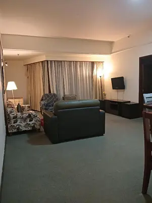a living room with a couch and a television at Services Star Apartment At Times Square KL in Kuala Lumpur