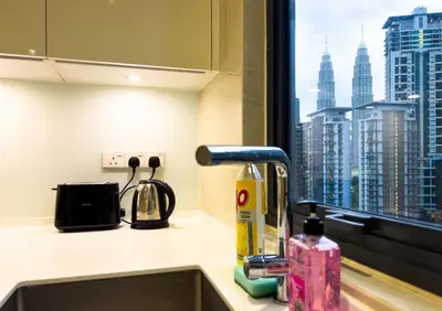 a kitchen sink with a view of a city skyline at Manor Residences KLCC in Kuala Lumpur