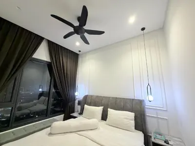 a bedroom with a bed with a ceiling fan at Lucentia Residence Bukit Bintang LalaportBBCC By VELLORA in Kuala Lumpur