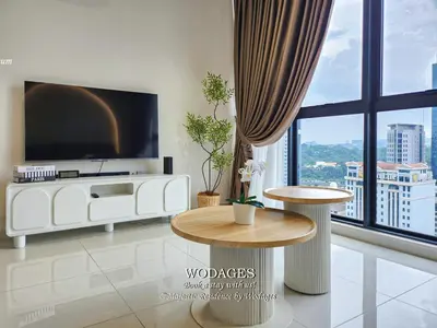 a living room with a flat screen tv and a table at Majestic Residence KL by Wodages in Kuala Lumpur