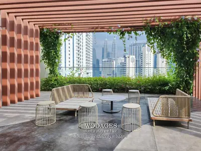 a patio with a table and chairs with a view of a city at Majestic Residence KL by Wodages in Kuala Lumpur