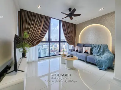 a living room with a blue couch and a large window at Majestic Residence KL by Wodages in Kuala Lumpur