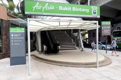 a bus stop with a sign in front of a building at Fahrenheit88 Suites Bukit Bintang B 2R in Kuala Lumpur