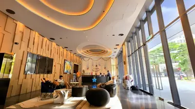 a lobby with people sitting in chairs in a building at Urban Starscape 50450, KL in Kuala Lumpur