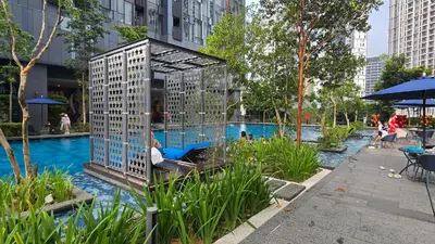 a bird cage is sitting next to a pool at Urban Starscape 50450, KL in Kuala Lumpur