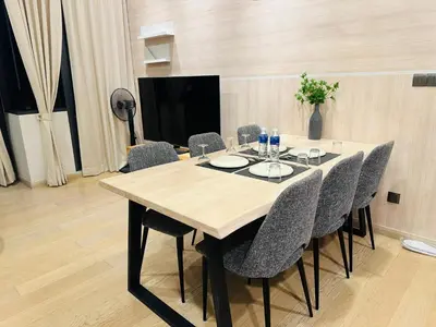 a dining room table with chairs and a television at Urban Starscape 50450, KL in Kuala Lumpur