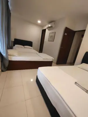 a hotel room with two beds with white sheets at HOTEL NoVA in Kuala Lumpur