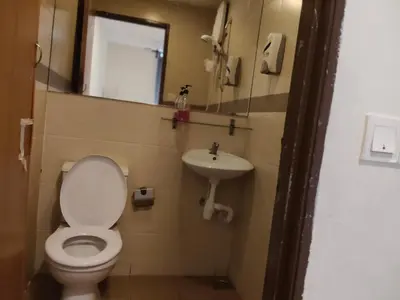 a bathroom with a toilet and a sink at HOTEL NoVA in Kuala Lumpur