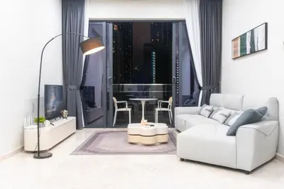 a living room with a white couch and a table at KLCC View Suites with balcony at The Manor Residence in Kuala Lumpur