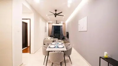 a dining room and living room with a table and chairs at KLCC View Suites with balcony at The Manor Residence in Kuala Lumpur