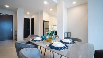 a dining room with a table and chairs at KLCC View Suites with balcony at The Manor Residence in Kuala Lumpur
