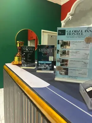 a display with a trophy on top of a counter at KING HOSTEL by Global Inn in Kuala Lumpur