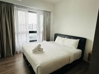 a bed with a teddy bear sitting on top of it at Residence Agile Apartment at kulalampur in Kuala Lumpur