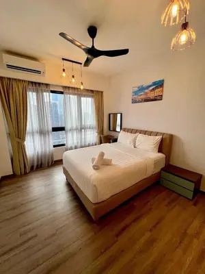 a bedroom with a bed with a ceiling fan at Residence Agile Apartment at kulalampur in Kuala Lumpur