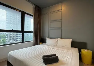 a bedroom with a large bed with a chair on it at Affordable at Arte Plus near KLCC with WiFi and Parking in Kuala Lumpur
