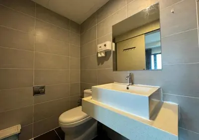 a bathroom with a sink and a toilet and a mirror at Affordable at Arte Plus near KLCC with WiFi and Parking in Kuala Lumpur