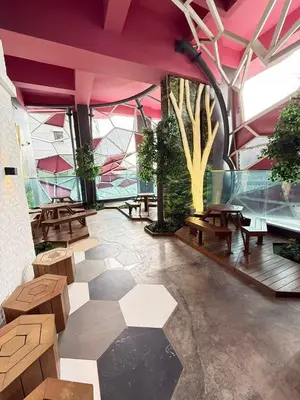 a room with tables and benches in a building at Affordable at Arte Plus near KLCC with WiFi and Parking in Kuala Lumpur