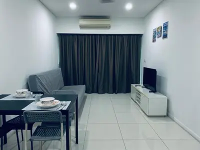 a living room with a couch and a table and a television at Summer Suites KLCC by Vho'Z in Kuala Lumpur