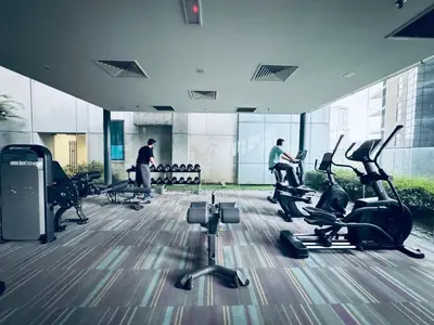 a gym with people exercising on treadmills in a building at Summer Suites KLCC by Vho'Z in Kuala Lumpur