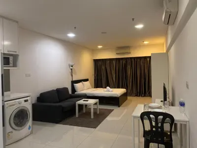 a living room with a couch and a bed at Summer Suites KLCC by Vho'Z in Kuala Lumpur
