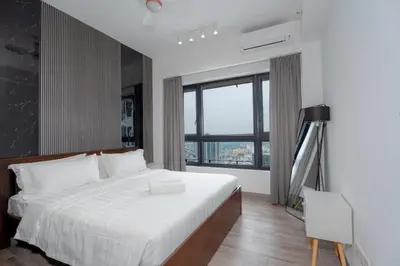 a bedroom with a white bed and a large window at Agile Bukit Bintang, 54th Floor Apt, Infinity Pool in Kuala Lumpur