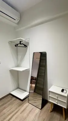 a mirror and a dresser in a room at Agile Bukit Bintang, 54th Floor Apt, Infinity Pool in Kuala Lumpur