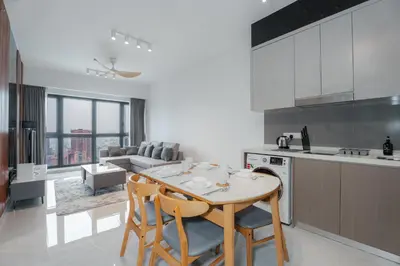 a kitchen and living room with a table and chairs at Agile Bukit Bintang, 54th Floor Apt, Infinity Pool in Kuala Lumpur
