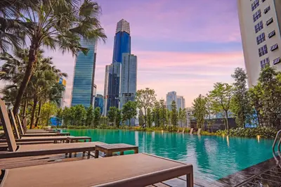a swimming pool with benches and a city skyline at Agile Bukit Bintang, 54th Floor Apt, Infinity Pool in Kuala Lumpur