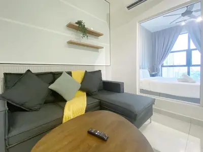 a living room with a couch and a table at Arte mont kiara by Paradigm Stay Free Parking in Kuala Lumpur