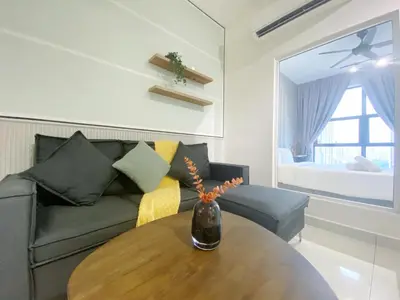 a living room with a couch and a wooden table at Arte mont kiara by Paradigm Stay Free Parking in Kuala Lumpur