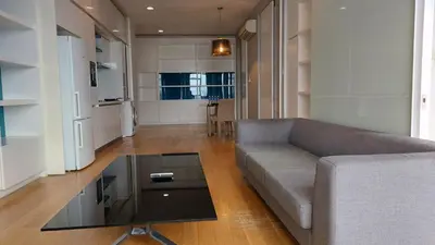 a living room with a couch and a glass table at Aura Suites at Platinum KLCC in Kuala Lumpur