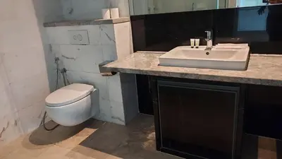 a bathroom with a white sink and a toilet at Aura Suites at Platinum KLCC in Kuala Lumpur
