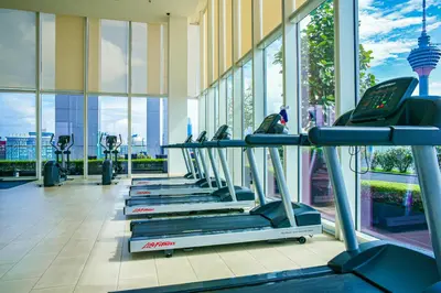 a gym with rows of treadmills in a building at Aura Suites at Platinum KLCC in Kuala Lumpur