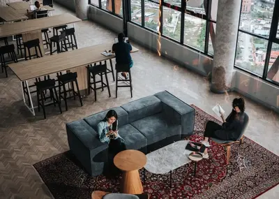 a group of people sitting on a couch in a room at Scarletz Suites KLCC Rooftop Infinity Pool Near Twin Towers in Kuala Lumpur