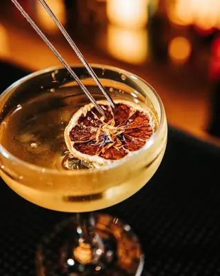 a drink in a glass dish on a table at Scarletz Suites KLCC Rooftop Infinity Pool Near Twin Towers in Kuala Lumpur