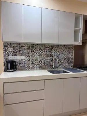 a kitchen with white cabinets and a sink at Prime location in Bukit Bintang, Studio for 2 in Kuala Lumpur