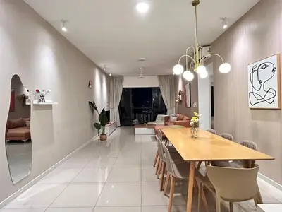 a dining room and living room with a table and chairs at Savio Residence in Kuala Lumpur