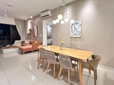 a dining room and living room with a table and chairs at Savio Residence in Kuala Lumpur