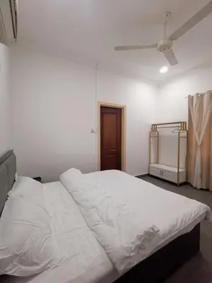 a white bed in a room with a ceiling fan at Sentul KL Private Cozy Bungalow Homestay - Free Parking & Wifi in Kuala Lumpur