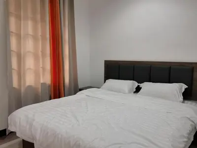 a large bed with white sheets and pillows at Sentul KL Private Cozy Bungalow Homestay - Free Parking & Wifi in Kuala Lumpur