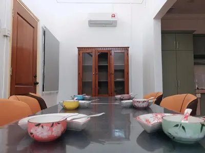 a dining room with a table with bowls on it at Sentul KL Private Cozy Bungalow Homestay - Free Parking & Wifi in Kuala Lumpur