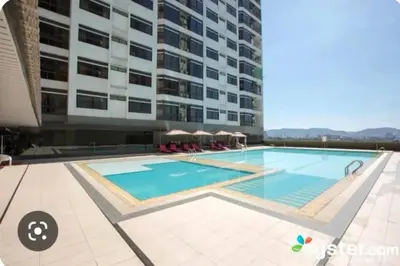 a swimming pool in front of a building at Fahrenheit88 Suites Bukit Bintang A 2R in Kuala Lumpur