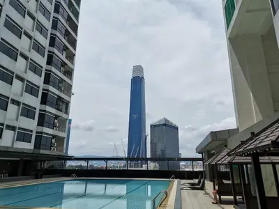 a swimming pool in a city with a tall building at Fahrenheit88 Suites Bukit Bintang A 2R in Kuala Lumpur