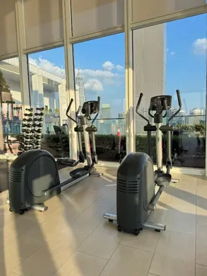a gym with cardio equipment in a large building at PLATINUM SUITES KLCC By CHENLUN in Kuala Lumpur