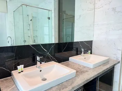 a bathroom with two sinks and a large mirror at PLATINUM SUITES KLCC By CHENLUN in Kuala Lumpur