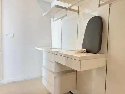 a dressing room with glass shelves and a chair at PLATINUM SUITES KLCC By CHENLUN in Kuala Lumpur
