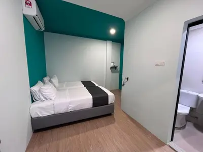 a bedroom with a bed and a green wall at Alami Garden Hotel Kuala Lumpur in Kuala Lumpur